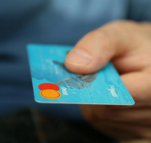 A person holding a credit card. Links to Gifts of Cash, Checks, and Credit Cards A person holding a credit card. Links to Gifts of Cash, Checks, and Credit Cards
